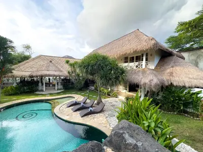a villa with a swimming pool and a resort at Villa Santai by Optimum Bali Villas in Canggu