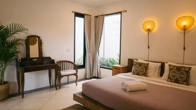 a bedroom with a bed and a mirror and a piano at Splendid 3 BR villa with large pool and garden in Canggu