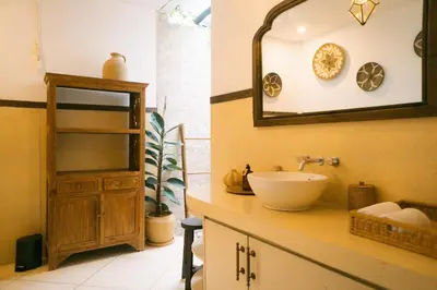 a bathroom with a sink and a mirror at Splendid 3 BR villa with large pool and garden in Canggu