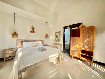 a bedroom with a large bed in a room at Villa Omarama Seminyak Beach in Seminyak