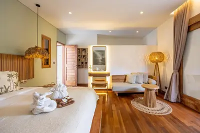 a living room with a bed and a couch at Villa Sebelah by Optimum Bali Villas in Seminyak