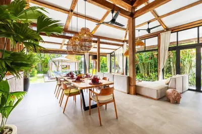 a dining room with a table and chairs at Villa Sebelah by Optimum Bali Villas in Seminyak