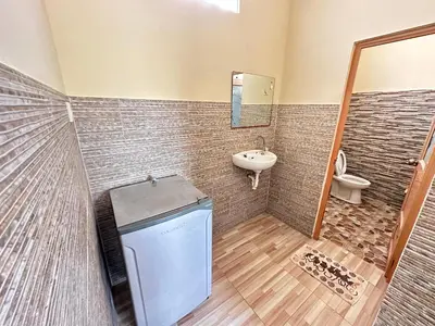 a bathroom with a sink and a toilet at Osa Guest House 5 in Seminyak