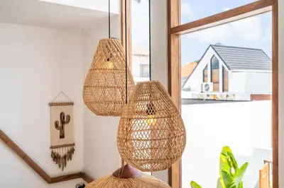 a room with two hanging lights and a mirror at Villa Monstera A7 By Aishwarya International in Kerobokan