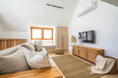 a living room with a couch and a tv at Villa Monstera A7 By Aishwarya International in Kerobokan