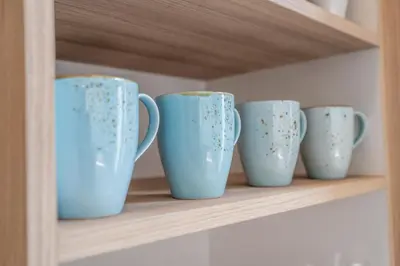 a row of blue cups sitting on a shelf at Villa Monstera A7 By Aishwarya International in Kerobokan