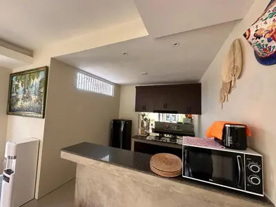 a kitchen with a counter top with a microwave at Villa Majegau 3, 3 bedrooms, Seminyak center in Seminyak