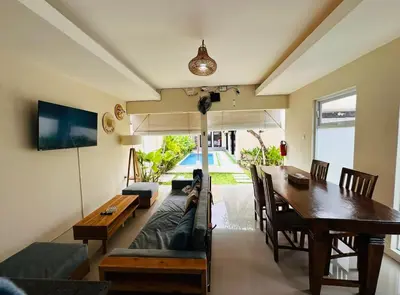 a living room with a couch and a table at Villa Majegau 3, 3 bedrooms, Seminyak center in Seminyak