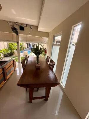 a dining room with a wooden table and chairs at Villa Majegau 3, 3 bedrooms, Seminyak center in Seminyak