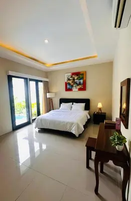 a large bedroom with a bed and a table at Villa Majegau 3, 3 bedrooms, Seminyak center in Seminyak