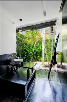 a living room with a table and a large window at Villa with 2 Bedrooms & Private Bathrooms near to the beach Seminyak in Seminyak
