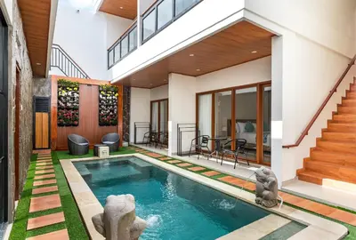 a swimming pool in the backyard of a house at The Saren CoLiving by SooBali in Kerobokan