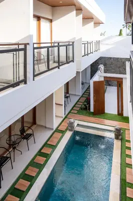 an apartment with a swimming pool in a building at The Saren CoLiving by SooBali in Kerobokan