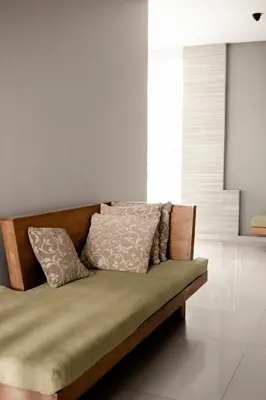 a couch with two pillows on it in a room at Bali Bliss Residence in Seminyak