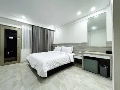 a bedroom with a large bed and a television at Jayakarta 6508 Legian Beach Side 2 BR Apartment in Seminyak