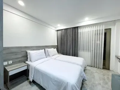 a bedroom with a large white bed and a window at Jayakarta 6508 Legian Beach Side 2 BR Apartment in Seminyak
