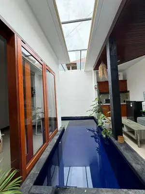 a house with a pool in the middle of a room at CWB Villa in Kerobokan