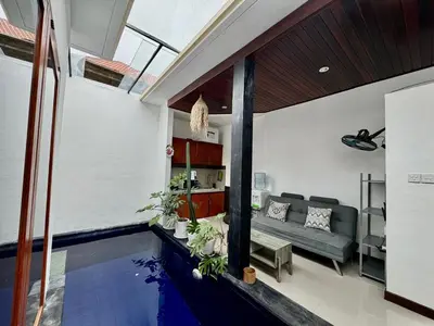 a house with a swimming pool in a living room at CWB Villa in Kerobokan