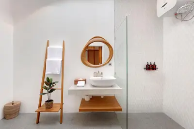 a bathroom with a sink and a mirror at Summer Cinta Seminyak in Seminyak