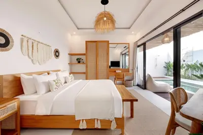 a bedroom with a bed and a living room at Summer Cinta Seminyak in Seminyak