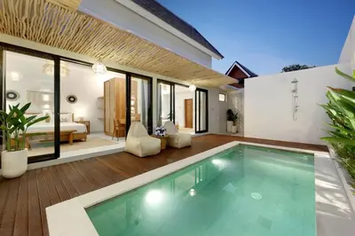 a villa with a swimming pool and a bedroom at Summer Cinta Seminyak in Seminyak