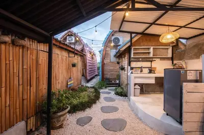 an outdoor kitchen with a refrigerator and a counter at Little Farm House Kerobokan near Seminyak in Kerobokan