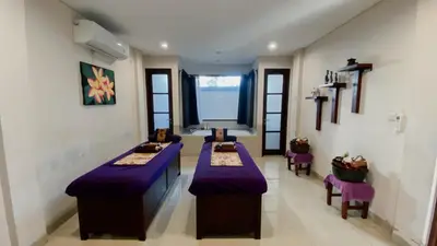 a room with purple tables and chairs and a window at Esco Luxe Jimbaran in Jimbaran