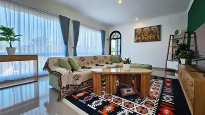 a living room with a couch and a table at MauLagi Bali Getaway in Jimbaran