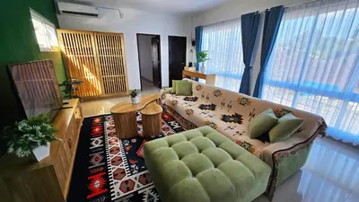 a living room with a couch and a table at MauLagi Bali Getaway in Jimbaran