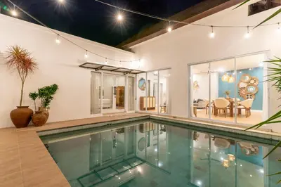 an indoor swimming pool in a house at Villa Palma Blanca Canggu by Nagisa Bali in Canggu
