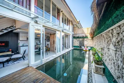 an external view of a house with a swimming pool at Villa Lotus by Unicorn Villas Bali in Kerobokan