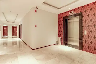 an empty room with a door and red wall at Dancenter Premium Legian Hotel in Balian