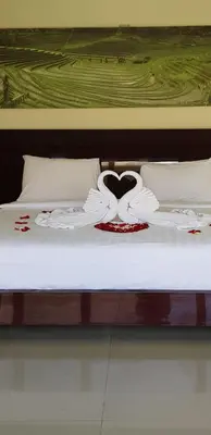 a bed with two swans in the shape of a heart at Privat Pool Villa with Kitchen at seminyak in Seminyak