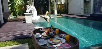 a tray of food on a table in a pool at Privat Pool Villa with Kitchen at seminyak in Seminyak