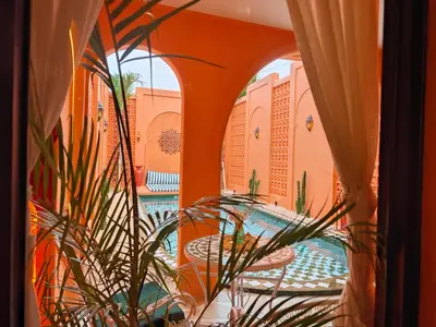 a view of a pool from a room with windows at Güzel Villa Bali in Badung