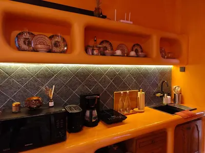 a kitchen with a counter top with a microwave at Güzel Villa Bali in Badung