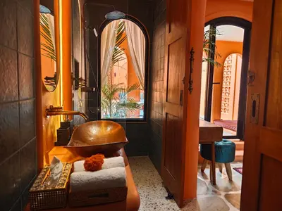 a bathroom with a copper sink and a mirror at Güzel Villa Bali in Badung