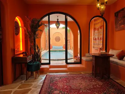 an orange hallway with an arched window and a pool at Güzel Villa Bali in Badung