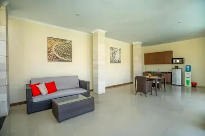 a living room with a couch and a kitchen at 1BR Private Pool Villa in Seminyak PB in Seminyak