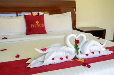 two swans wrapped in towels sitting on a bed at 1BR Private Pool Villa in Seminyak PB in Seminyak