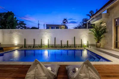 a swimming pool in the backyard of a house at Harmony Villa Two Bedroom in Canggu