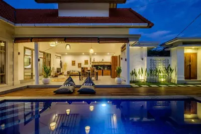 a house with a swimming pool in front of a house at Harmony Villa Two Bedroom in Canggu