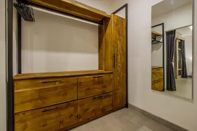 a large wooden dresser in a room with a mirror at Harmony Villa Two Bedroom in Canggu