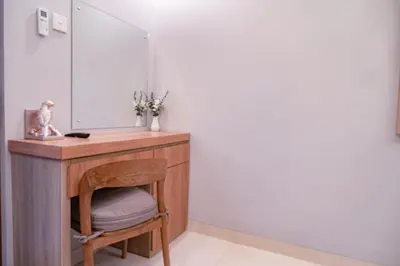 a dressing table with a chair and a mirror at D'House Seminyak in Seminyak