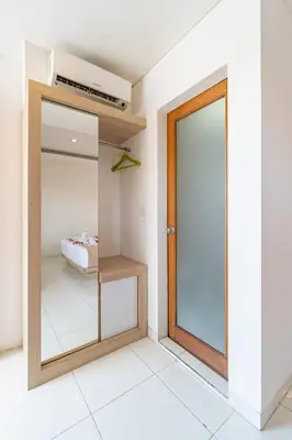 a room with a closet with a glass door at Srikrisna in Seminyak