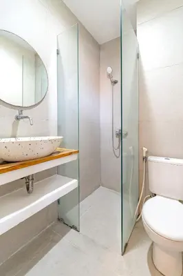 a bathroom with a sink and a toilet and a mirror at Srikrisna in Seminyak