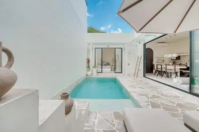 a swimming pool in the middle of a house at Villa Madame 3BR Villa Private Pool in Berawa in Canggu