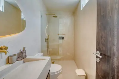 a bathroom with a shower and a toilet and a sink at Villa Madame 3BR Villa Private Pool in Berawa in Canggu