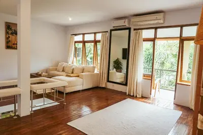 a living room with a couch and a table at Villa Frankie in Central Legian in Legian