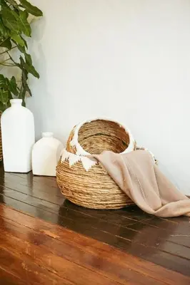 a basket sitting on a floor with two vases at Villa Frankie in Central Legian in Legian